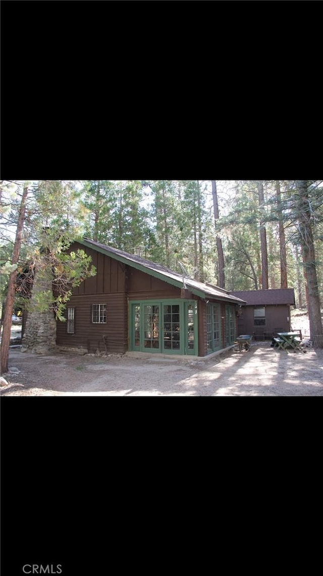 rear view of house with board and batten siding