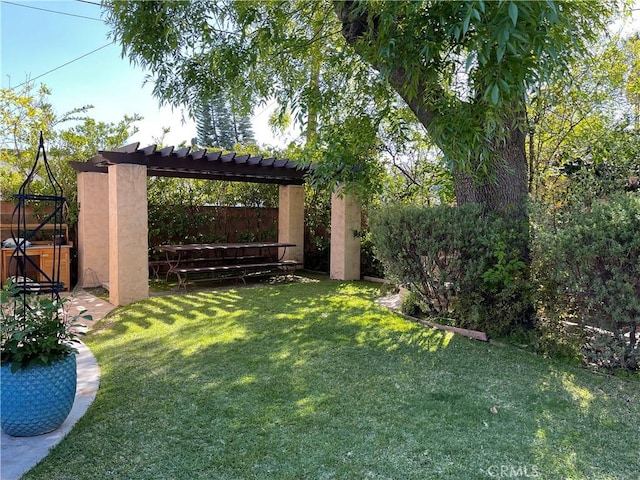 view of yard featuring a pergola and fence