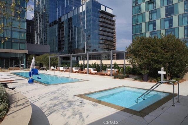 community pool featuring a patio area and a hot tub