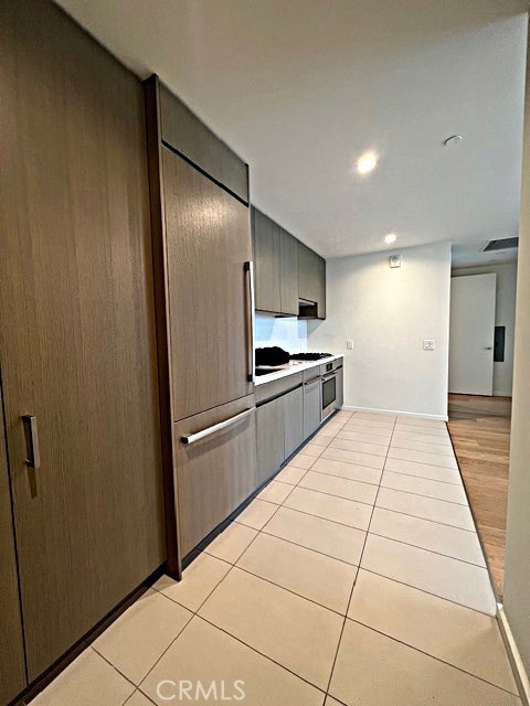 kitchen featuring light countertops, light tile patterned floors, and visible vents