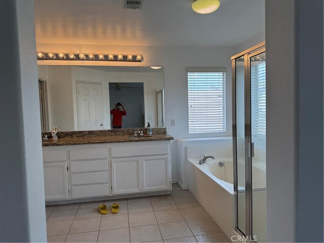 full bathroom with visible vents, tile patterned floors, ceiling fan, double vanity, and a bath