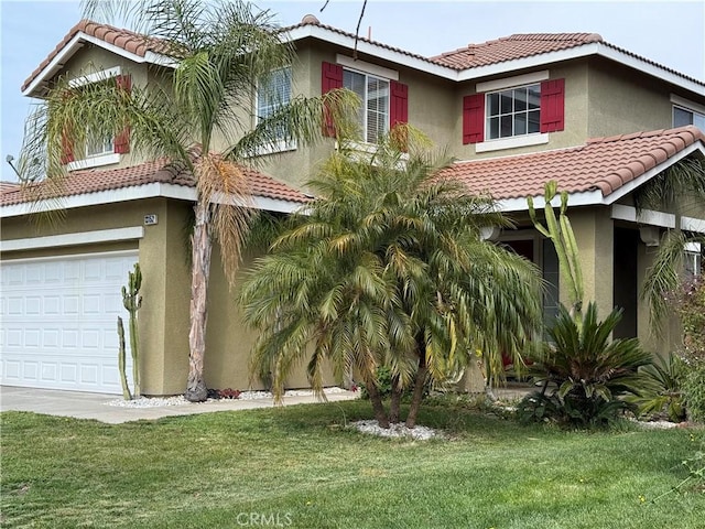 view of front facade with a front yard, a tiled roof, and stucco siding