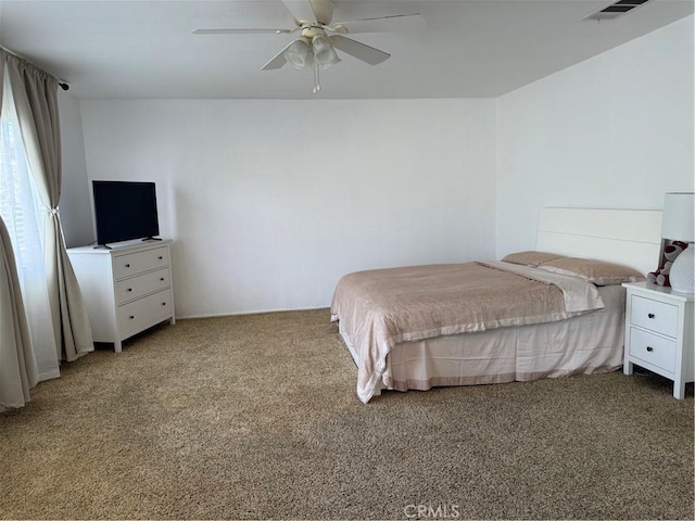 bedroom featuring visible vents, light carpet, and a ceiling fan