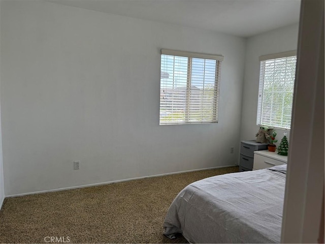 carpeted bedroom featuring baseboards