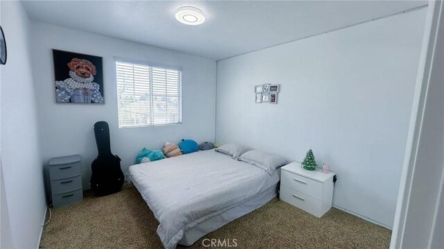 bedroom with light colored carpet