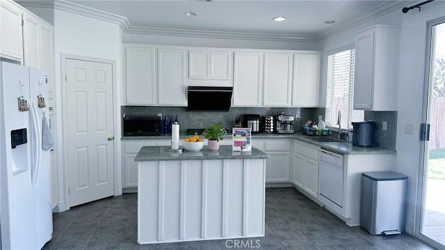 kitchen featuring white cabinets, tasteful backsplash, a sink, and white appliances