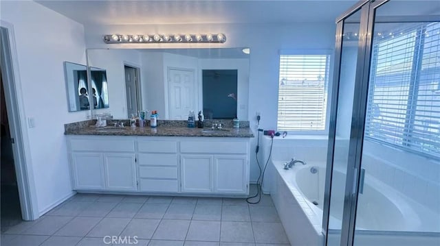 full bathroom with a garden tub, tile patterned floors, a sink, double vanity, and an enclosed shower