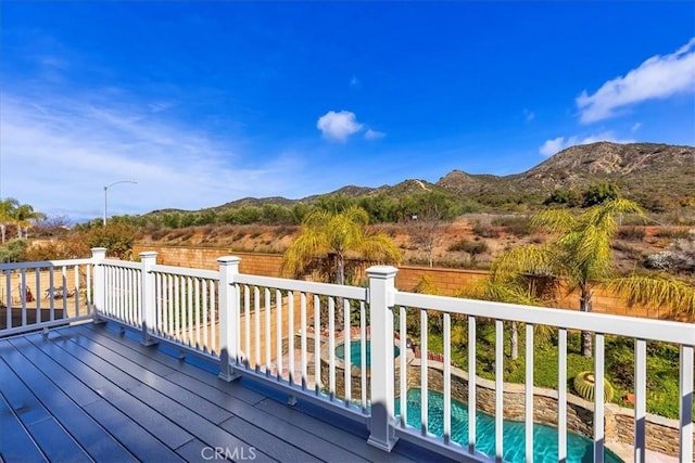 wooden terrace featuring a pool and a mountain view