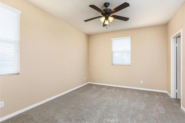 unfurnished bedroom with carpet flooring, baseboards, and ceiling fan