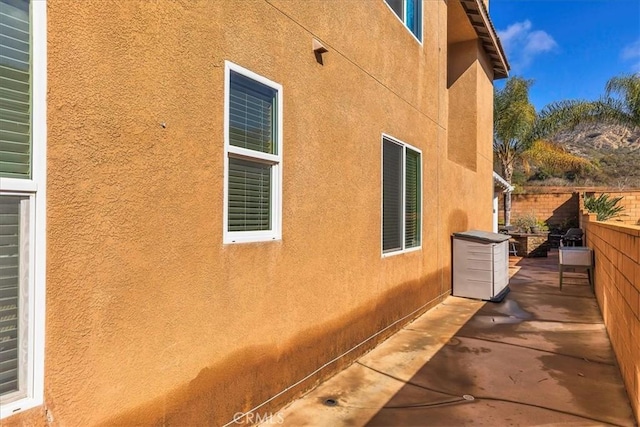 view of home's exterior featuring a patio, fence, and stucco siding