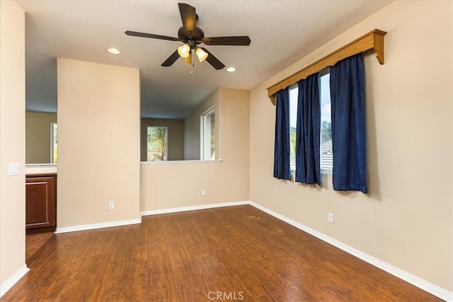 spare room featuring recessed lighting, baseboards, and wood finished floors