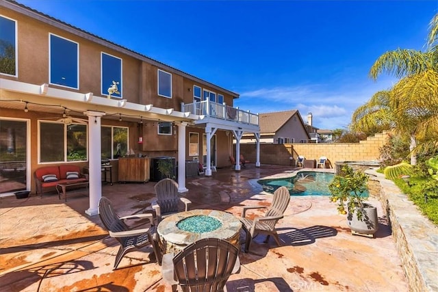 view of patio / terrace with an outdoor living space with a fire pit, fence, and a fenced in pool