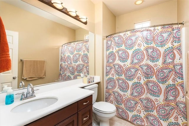 bathroom featuring tile patterned flooring, a shower with shower curtain, toilet, and vanity