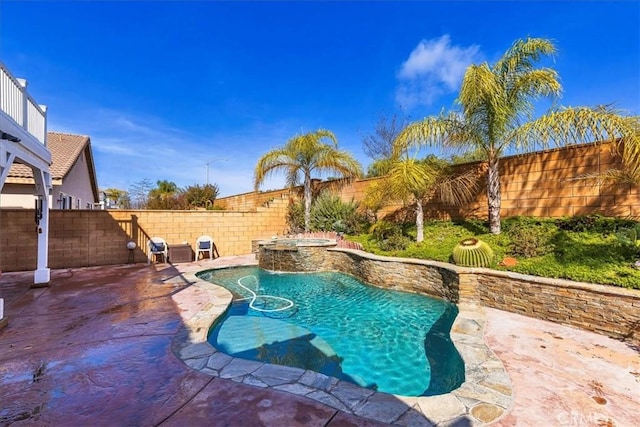 view of pool featuring a patio area, a pool with connected hot tub, and a fenced backyard