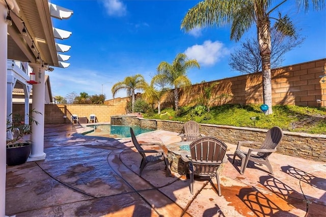 view of patio / terrace featuring a fenced backyard and a fenced in pool