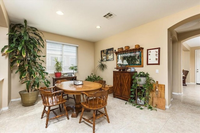 dining space with recessed lighting, arched walkways, visible vents, and baseboards