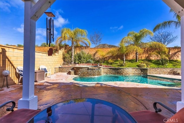 view of swimming pool featuring a fenced in pool, a patio, an in ground hot tub, and a fenced backyard