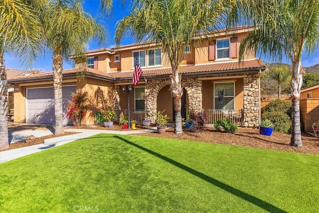 mediterranean / spanish home featuring stucco siding, a front lawn, an attached garage, and a tile roof