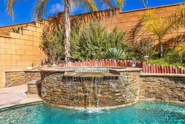 view of pool with a fenced backyard