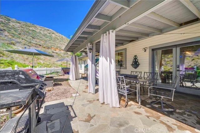 39100 Saddle Ridge Rd, Hemet, CA 92543 - view of patio with area for grilling, a mountain view, outdoor dining area, and fence