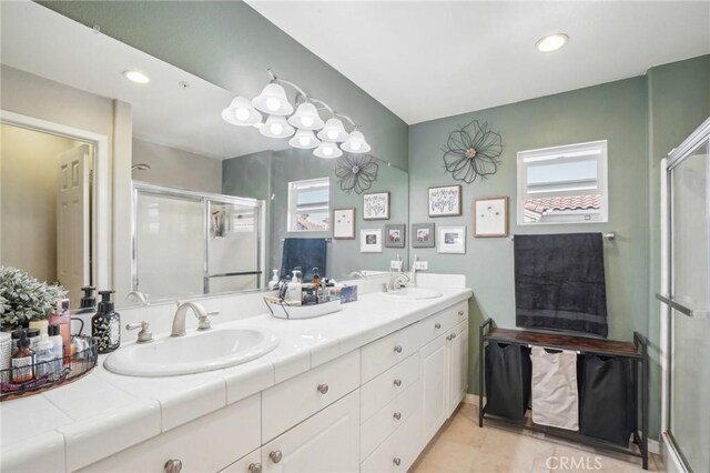 2810 Green River Rd Unit 103, Corona, CA 92882 - full bathroom featuring a stall shower, double vanity, tile patterned floors, and recessed lighting