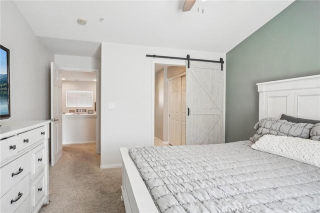 2810 Green River Rd Unit 103, Corona, CA 92882 - bedroom with a barn door, light carpet, and a ceiling fan