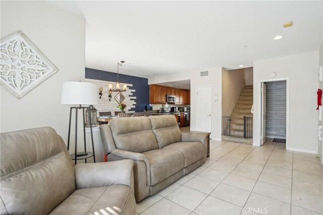 2810 Green River Rd Unit 103, Corona, CA 92882 - living area featuring stairway, a chandelier, light tile patterned floors, baseboards, and recessed lighting