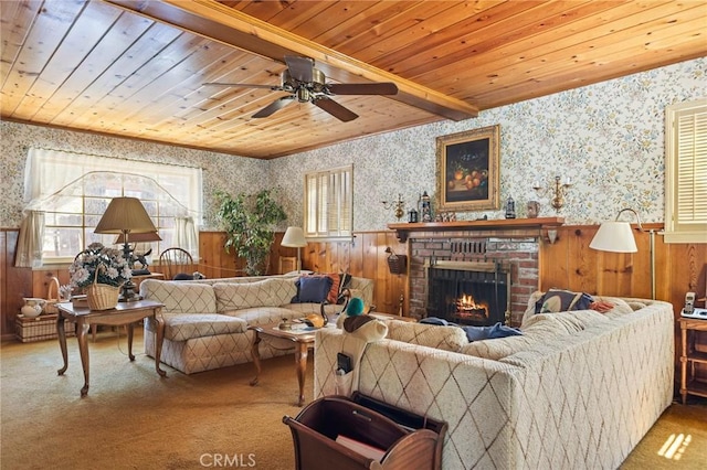 living room with wallpapered walls, wooden ceiling, carpet, and wainscoting