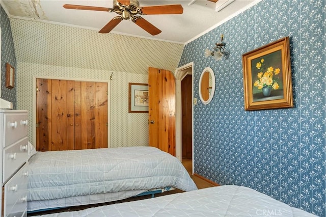 bedroom with ceiling fan, ornamental molding, and wallpapered walls