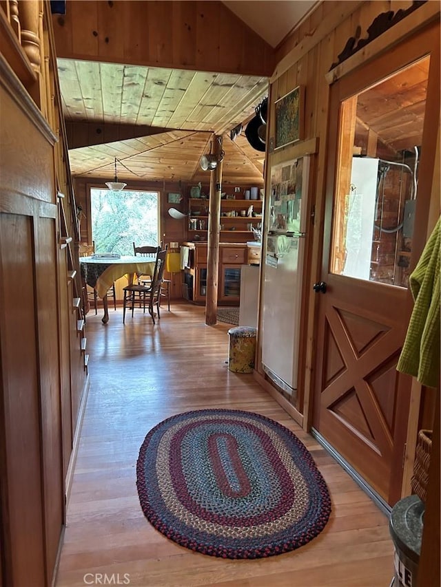 interior space featuring wooden walls, wooden ceiling, and wood finished floors