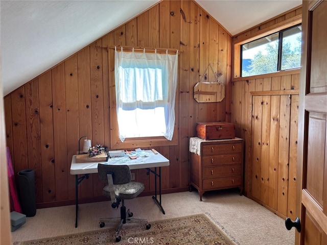 office space with carpet floors, wood walls, and lofted ceiling