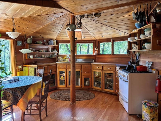 kitchen with open shelves, wooden ceiling, gas range gas stove, and a wealth of natural light