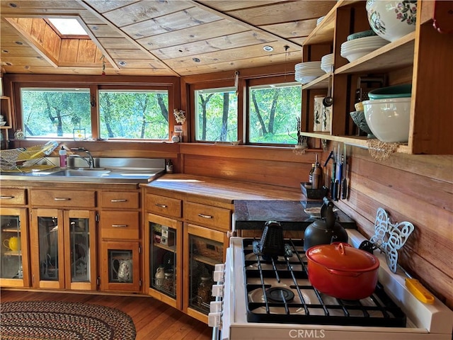 kitchen with brown cabinets, open shelves, stove, hardwood / wood-style floors, and wood ceiling