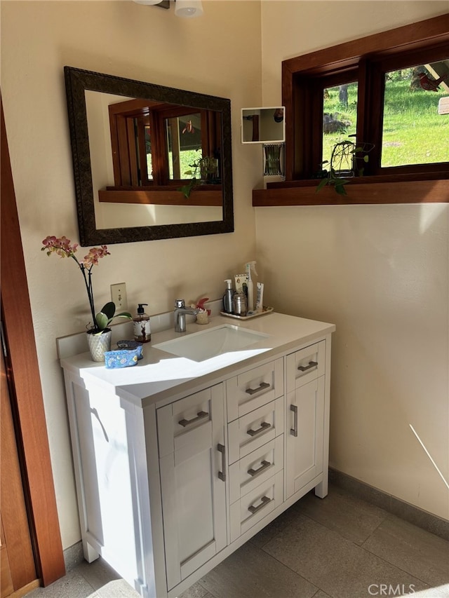 bathroom with baseboards and vanity
