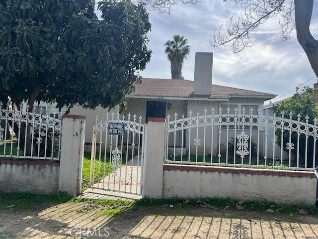 view of gate with a fenced front yard