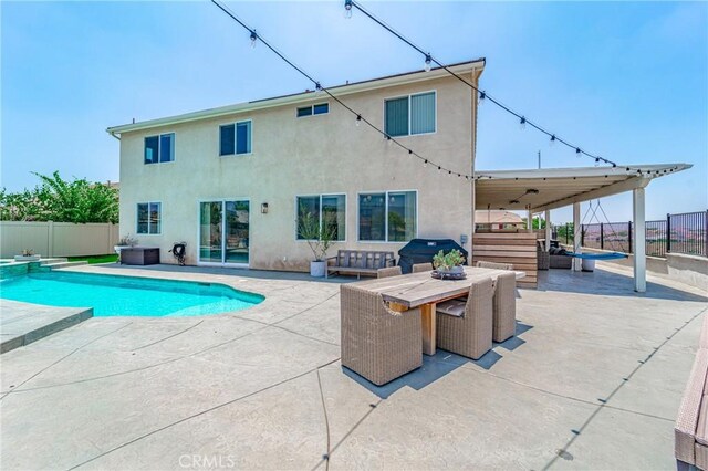 148 Mesquite Ct, Calimesa, CA 92320 - view of swimming pool featuring a fenced backyard, outdoor dining space, a pool with connected hot tub, and a patio area
