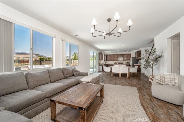 148 Mesquite Ct, Calimesa, CA 92320 - living room featuring a notable chandelier, dark wood-type flooring, and recessed lighting