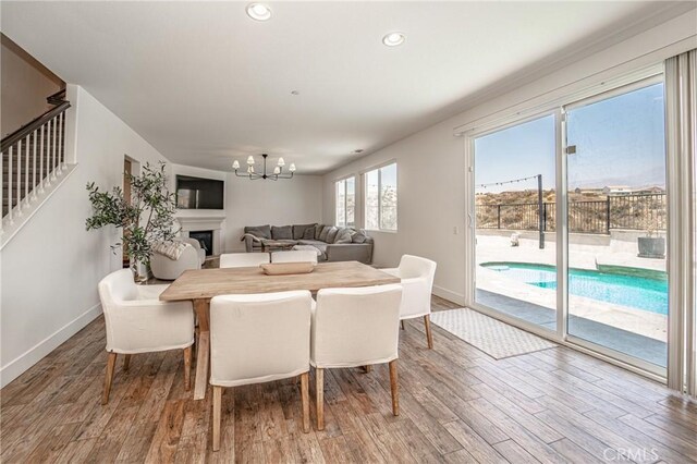 148 Mesquite Ct, Calimesa, CA 92320 - dining room with an inviting chandelier, baseboards, and wood finished floors
