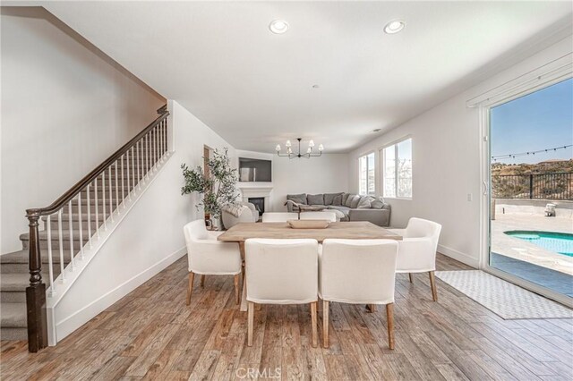 148 Mesquite Ct, Calimesa, CA 92320 - dining room featuring stairs, wood finished floors, baseboards, and a chandelier
