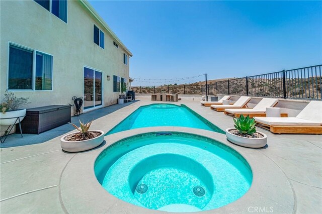 148 Mesquite Ct, Calimesa, CA 92320 - view of pool featuring a fenced in pool, an in ground hot tub, fence, and a patio area