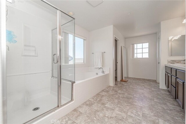 148 Mesquite Ct, Calimesa, CA 92320 - bathroom featuring vanity, a garden tub, and a shower stall