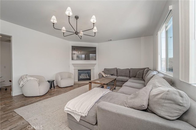 148 Mesquite Ct, Calimesa, CA 92320 - living room with a chandelier, wood finished floors, healthy amount of natural light, and a glass covered fireplace