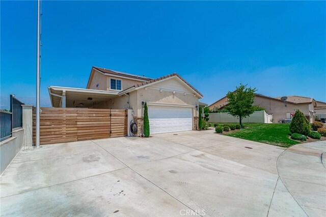 148 Mesquite Ct, Calimesa, CA 92320 - view of front of home featuring fence, an attached garage, concrete driveway, a front lawn, and stucco siding