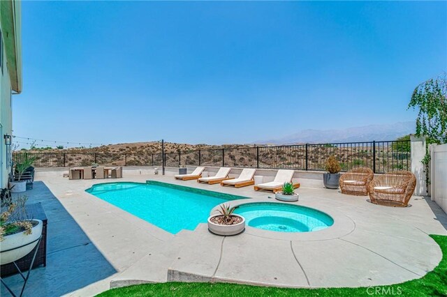148 Mesquite Ct, Calimesa, CA 92320 - view of swimming pool featuring an in ground hot tub, a fenced in pool, fence, a patio, and a mountain view