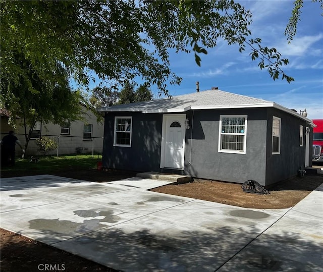 view of front of property with fence and stucco siding