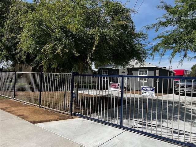 view of front of house featuring fence and a gate