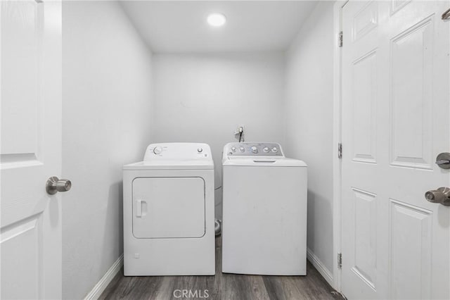 24412 Eucalyptus Ave, Moreno Valley, CA 92553 - laundry room with washing machine and dryer, dark wood-type flooring, and baseboards