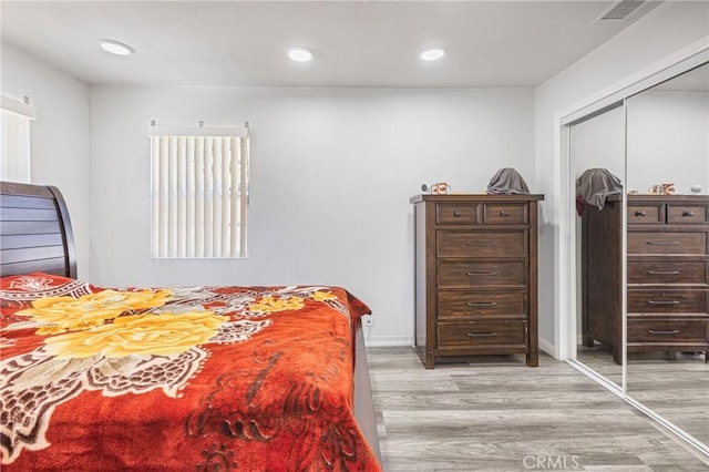 24412 Eucalyptus Ave, Moreno Valley, CA 92553 - bedroom with light wood-style flooring, a closet, and recessed lighting