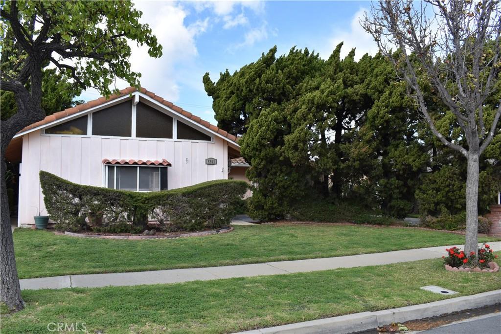 view of home's exterior with a tiled roof and a yard