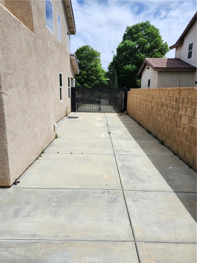 view of patio / terrace featuring fence and a gate